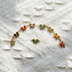 copper wrapped butterfly shape glass connectors with double loops ( horizontally left to right between chain)